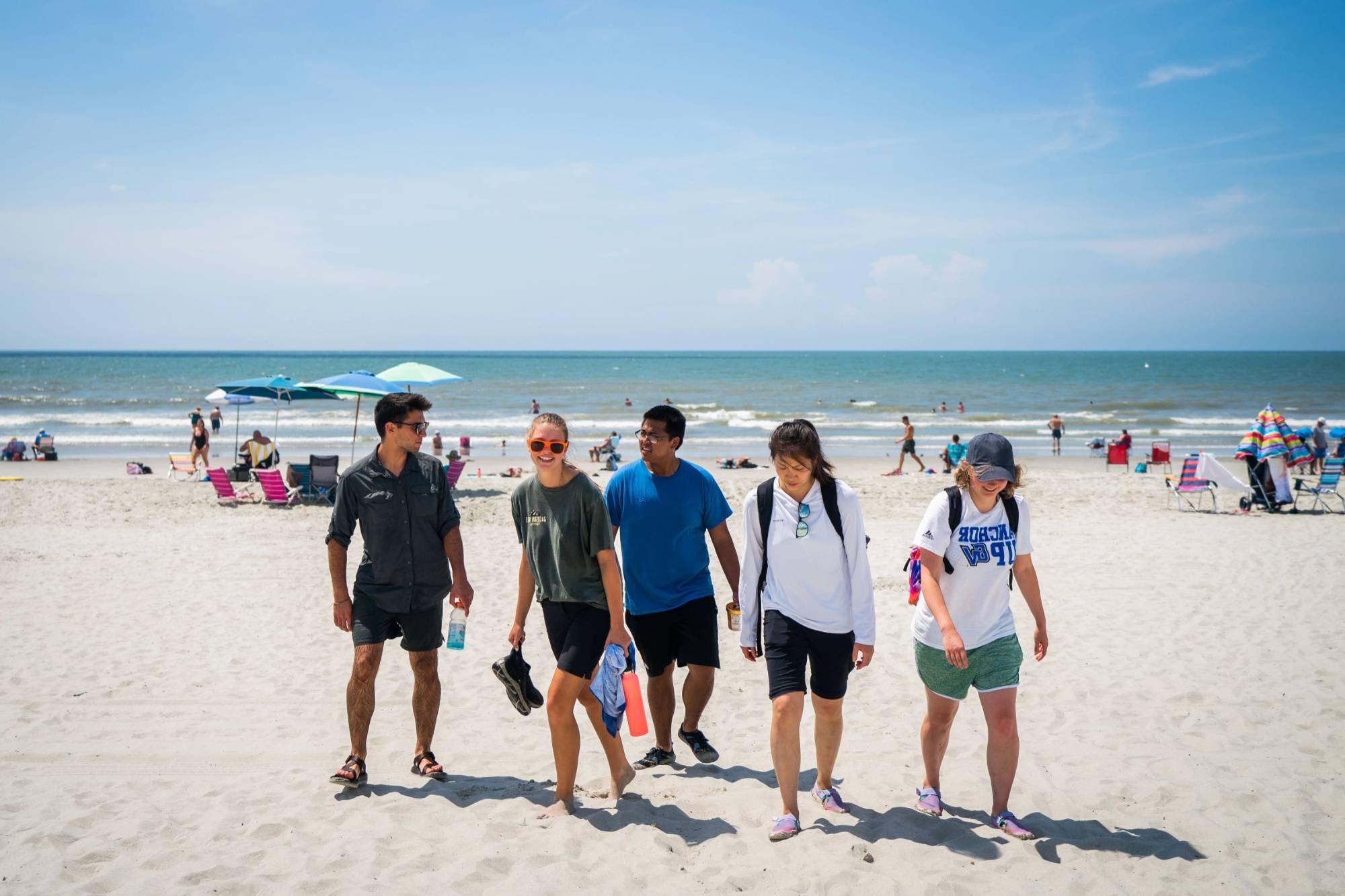 Students walking on a beach at Lake Michigan